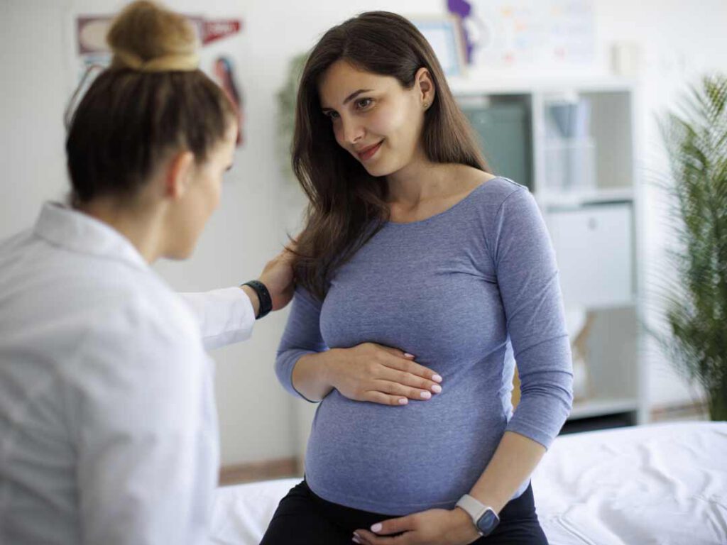 A doctor speaking with a pregnant woman